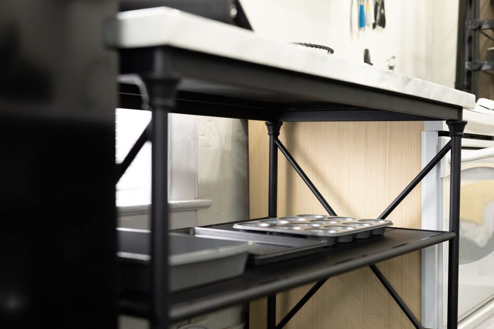 Well-equipped kitchen with a sleek design and a view of the rest of the space.