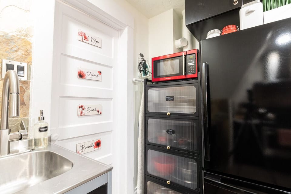 The kitchen's calming ambiance is enhanced by the warm lighting and decorative elements.