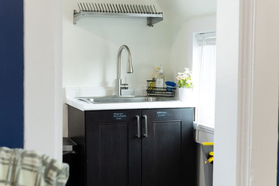 A functional kitchen with a window view, perfect for a relaxing stay.