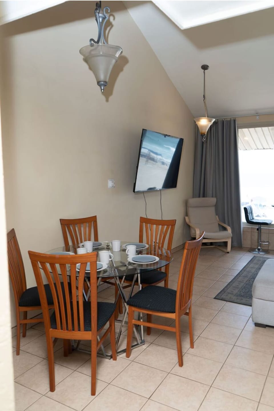 Dining table is also accompanied by a kitchen bar and coffee table for meals.