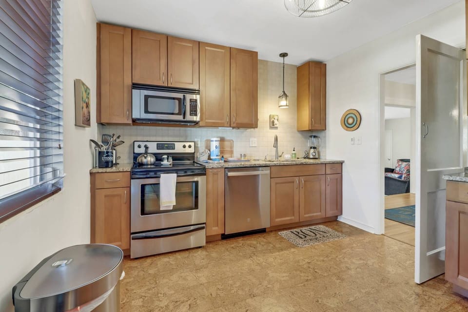 The remodeled and updated kitchen features full-size appliances, including oven, microwave, dishwasher and refrigerator/freezer.