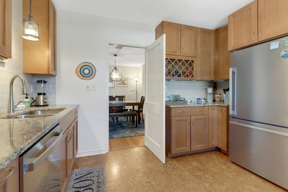 The kitchen has been newly remodeled with solid wood cabinetry, granite counters, tile backsplash and a touch mid-century charm!