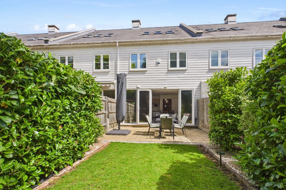 Private back garden with patio dining area and outdoor seating for six.