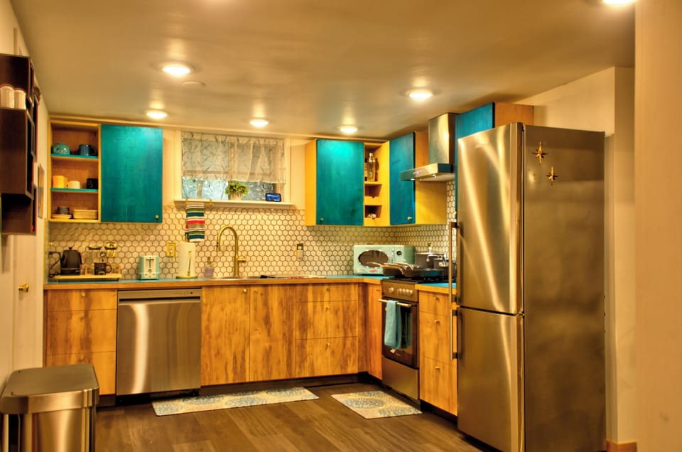 Hand crafted wood cabinets with brass honeycomb tile backsplash. 