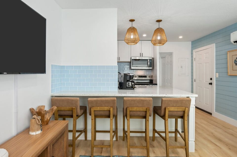 Chic chairs and a modern countertop create a perfect gathering spot.