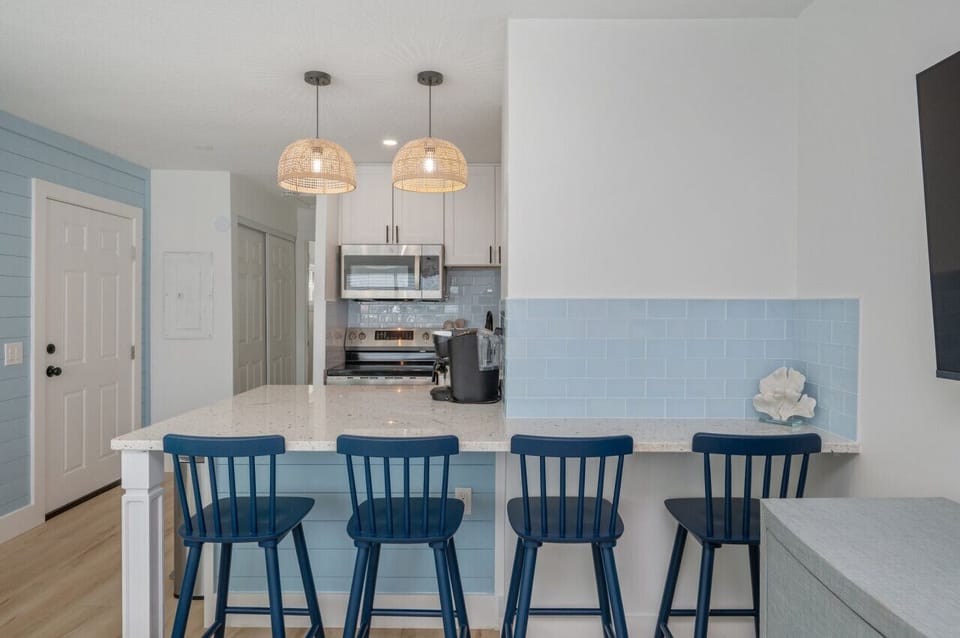 Chic chairs and a modern countertop create a perfect gathering spot.