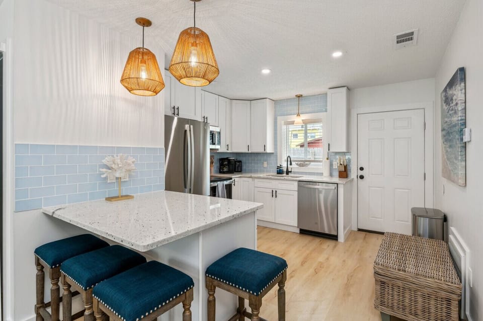 Chic chairs and a modern countertop create a perfect gathering spot.