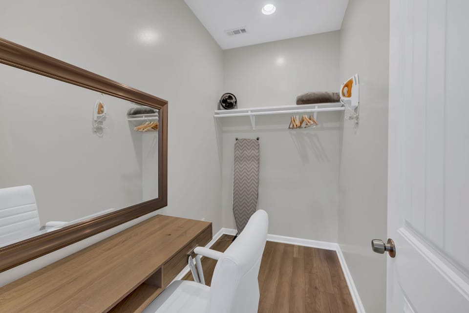A dedicated workspace awaits in the spacious walk-in closet.