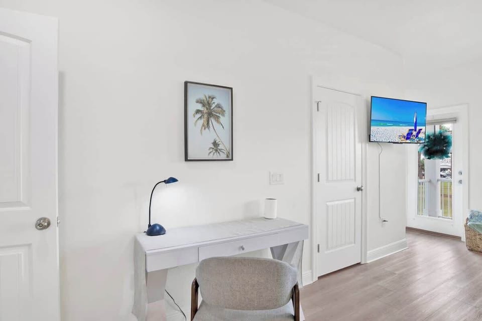 {MASTER BEDROOM} Includes a comfortable desk and chair, perfect for remote work or planning your day. This dedicated workspace combines functionality and style, allowing you to stay productive while enjoying the serene bay view.