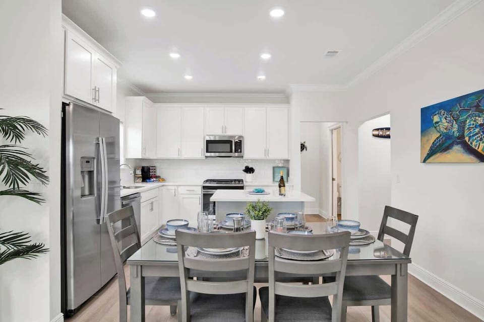 {DINING ROOM} Seamlessly connects to both the kitchen and living room in an open floor plan,creating a perfect flow for entertaining and family meals. This space allows for easy interaction, with natural light enhancing the warm, inviting atmosphere.