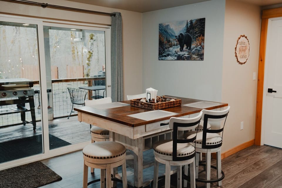 Dining Area - Main Level - Dining table w/4 chairs & 2 stools (seats 6). Additional seating (3 stools) at kitchen island.  Easy access to outdoor deck/grill!