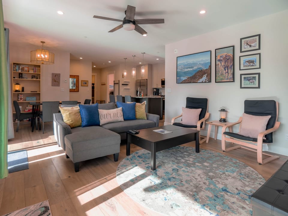 The living room features a comfortable couch that easily converts into a sofa bed.