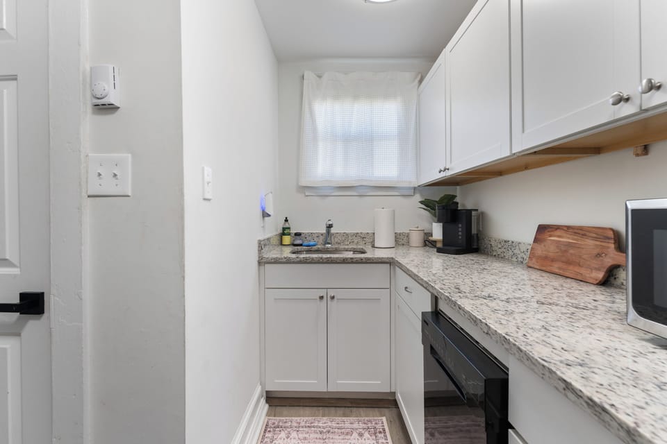 Modern kitchen with ample counter space, essentials, and sleek appliances.