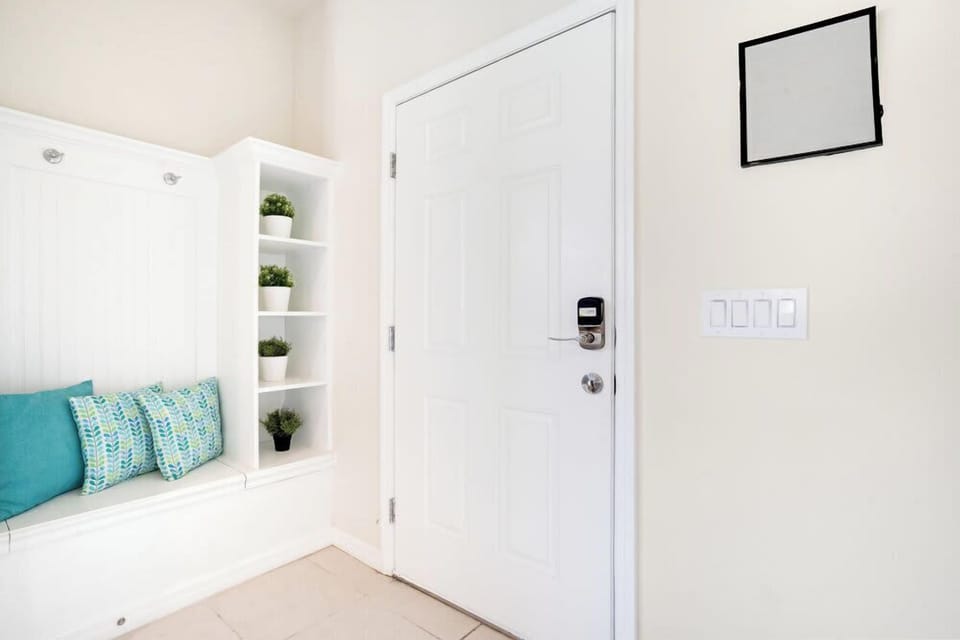 Entryway with built-in bench seating and decorative plants for a welcoming atmosphere