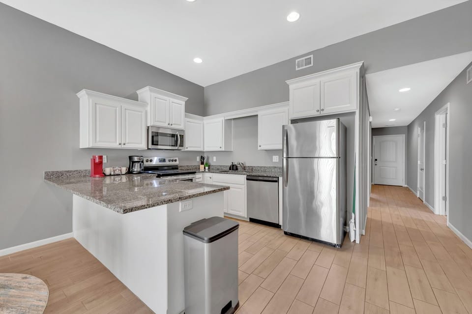The chefs kitchen is stocked and features stainless steel appliances and granite countertops.