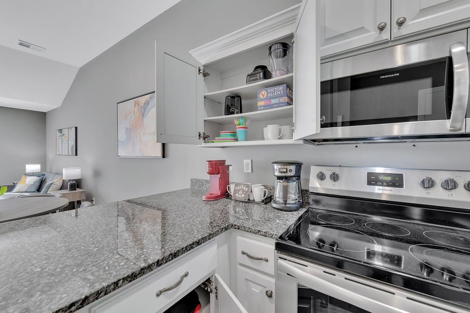 The kitchen includes cups, appliances to make this a home away from home