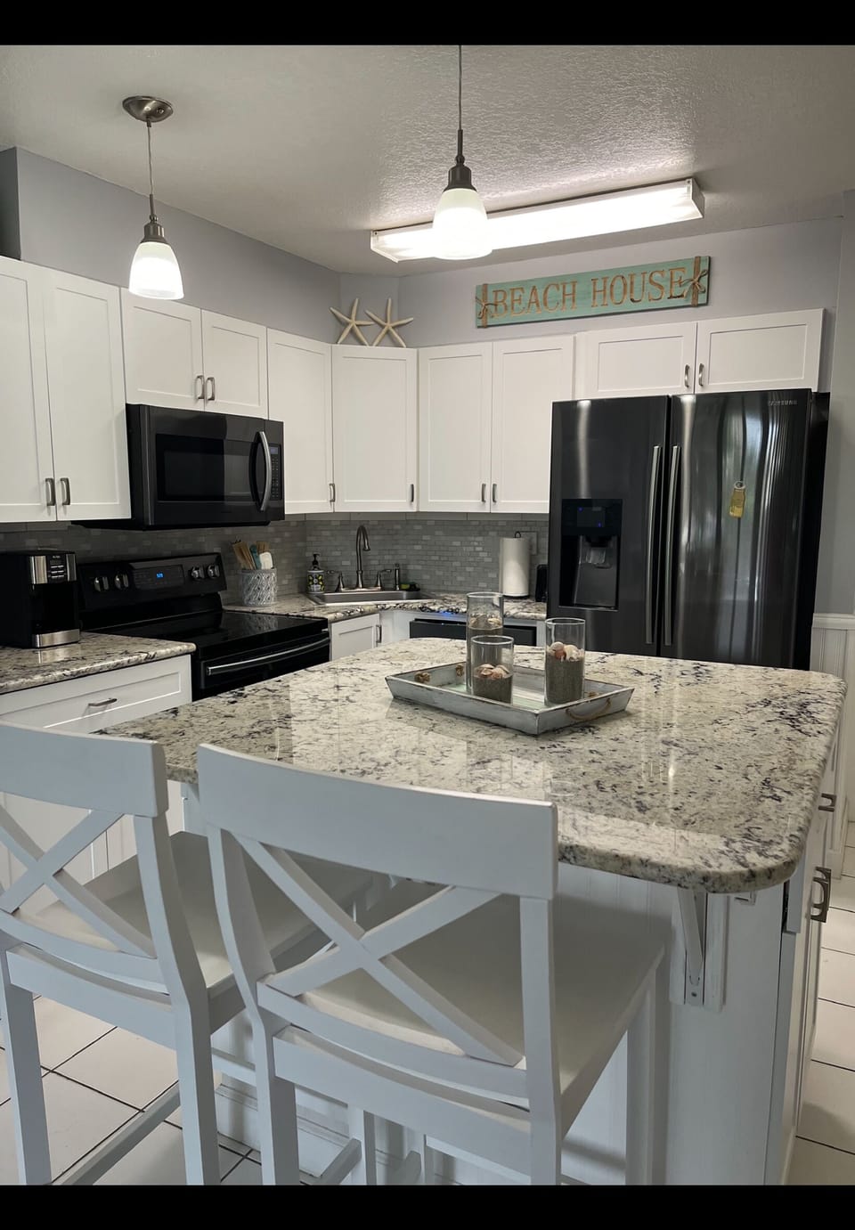 Kitchen has full size appliances, island seating for 4, and dishes/cookware