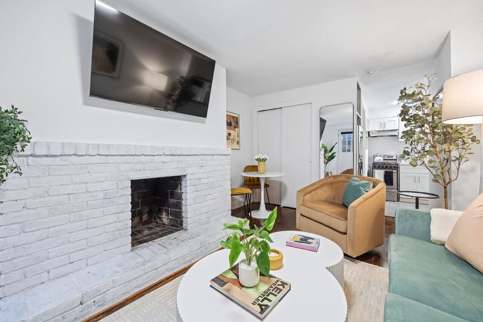 Indoor fireplace with wide flat screen smart TV.