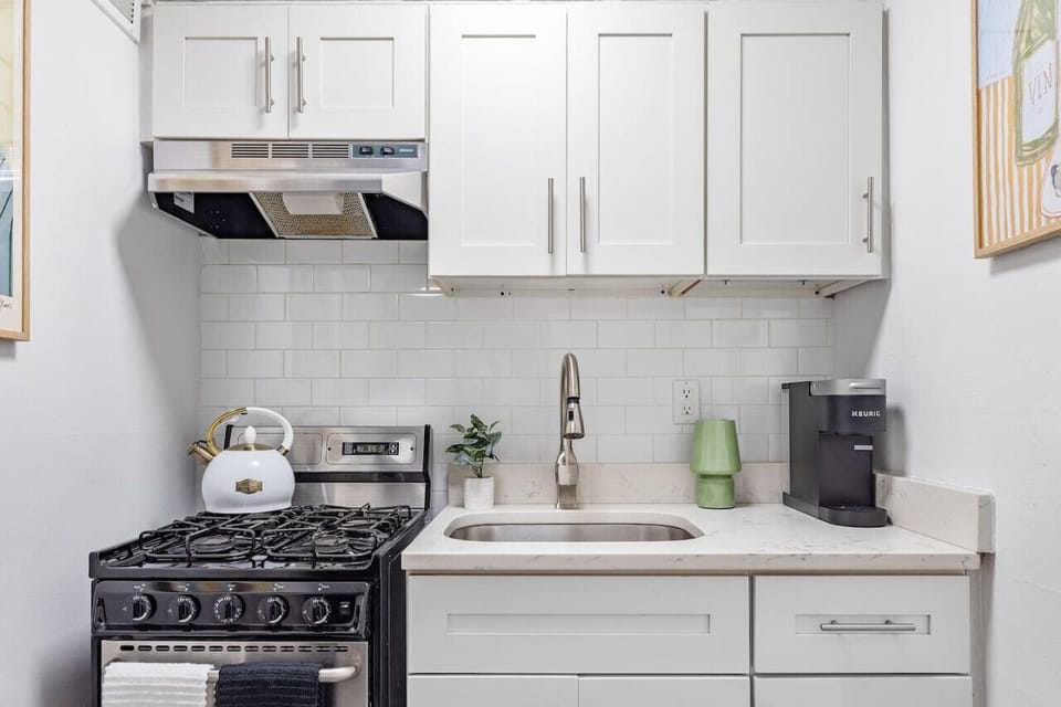 Fully equipped kitchen with stove top, oven, and coffee machine.