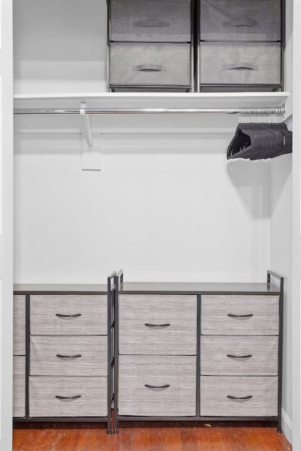 Spacious and versatile storage space with clothing rack and cabinets