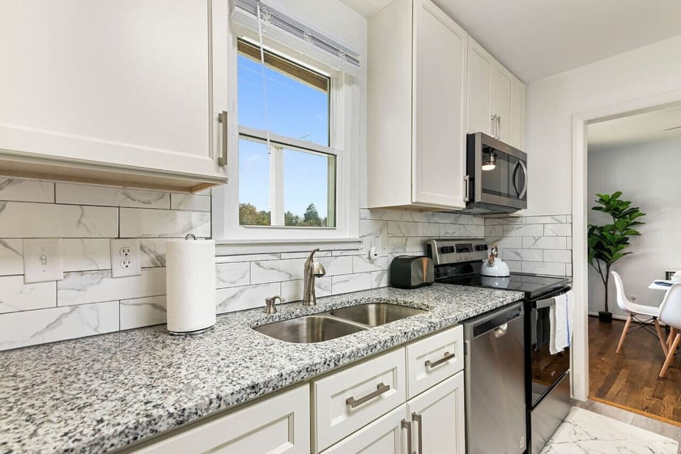 Embrace modern elegance with sleek white cabinets and stainless steel appliances, offering the perfect blend of style and functionality Kitchen