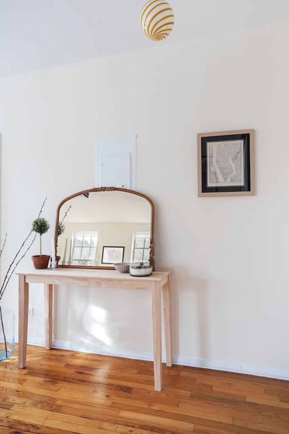 White walls and wooden floors with sophisticated decor