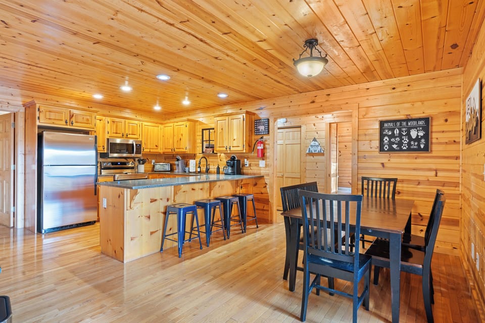 Rustic charm meets modern comfort in this cozy cabin kitchen and dining area.