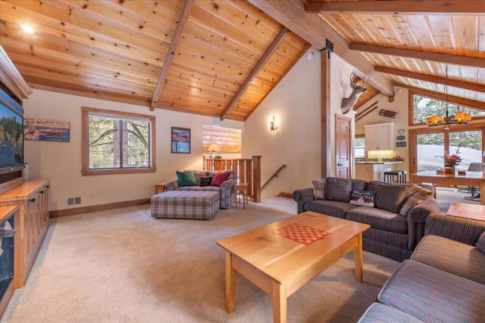 Lovely great room on main / upper floor with vaulted ceilings, fireplace and large flat screen TV.