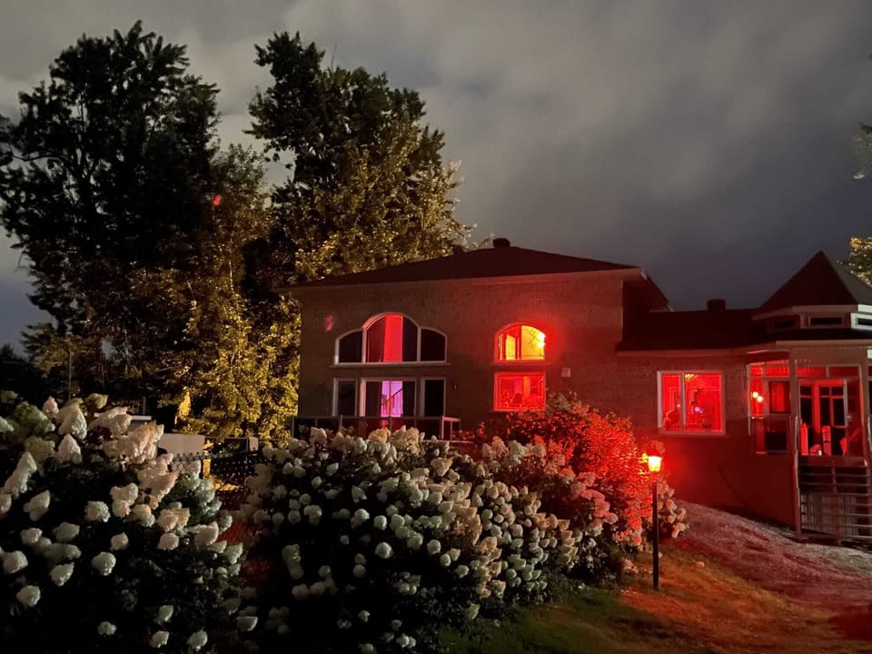 Exterior at night, showing Philips Hue color smart lighting system