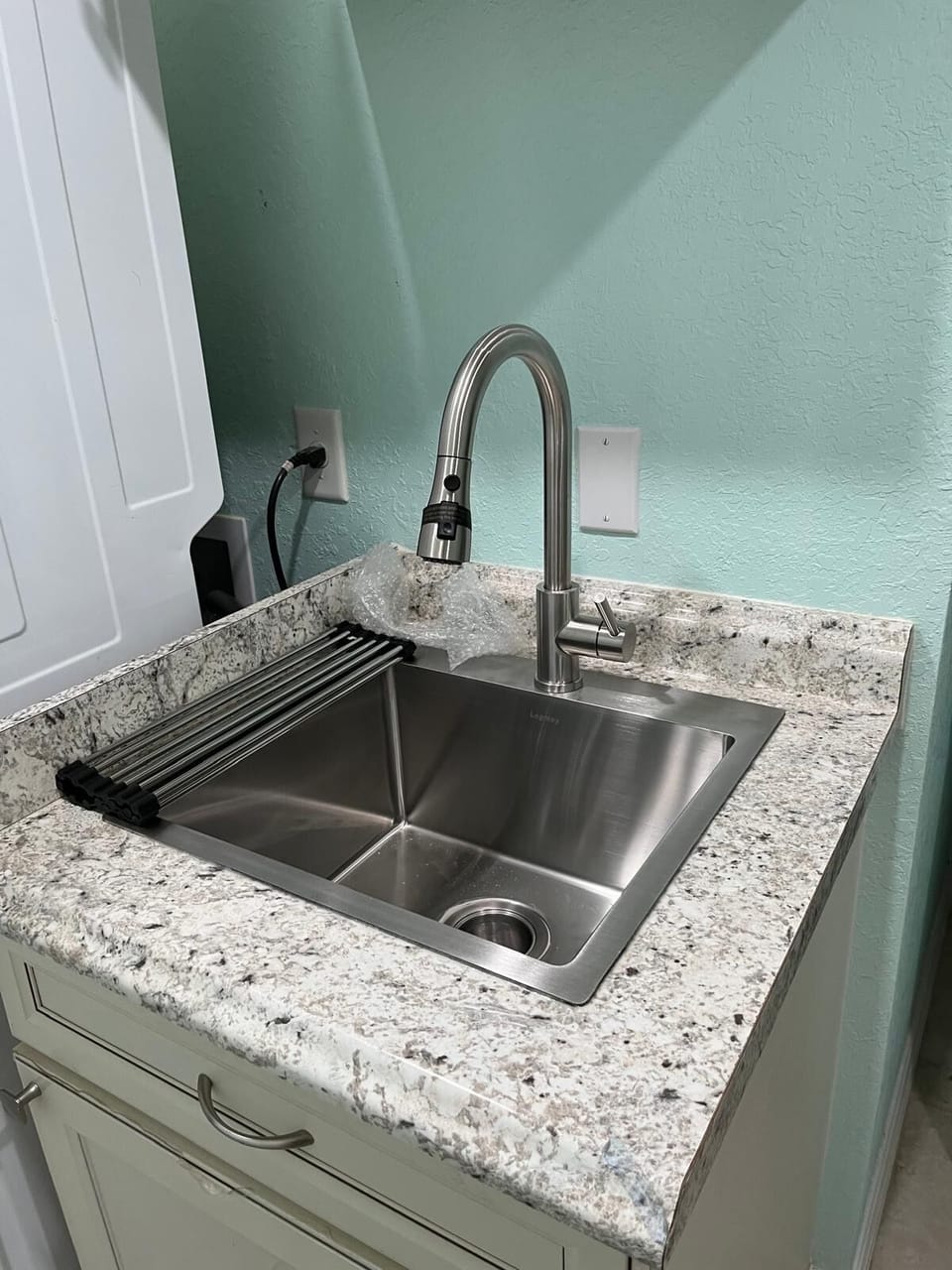 Comfortable laundry Area with sink