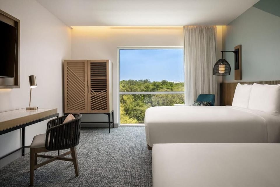 Unwind by the window, then catch up at the desk.