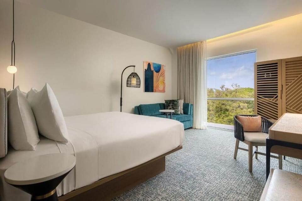 Relax in a serene king room with cozy sofa seating.