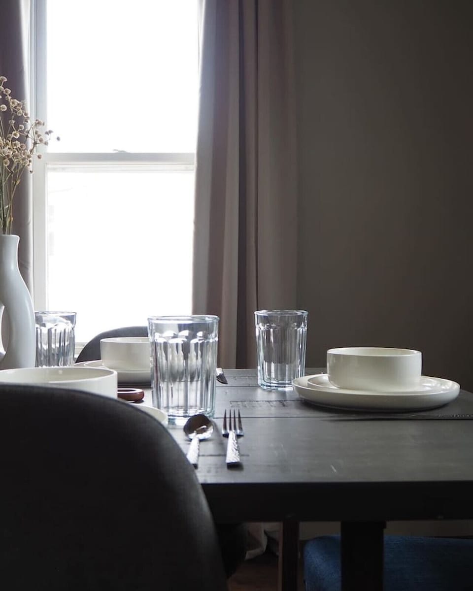 Dining nook with soft lighting and complete place settings.