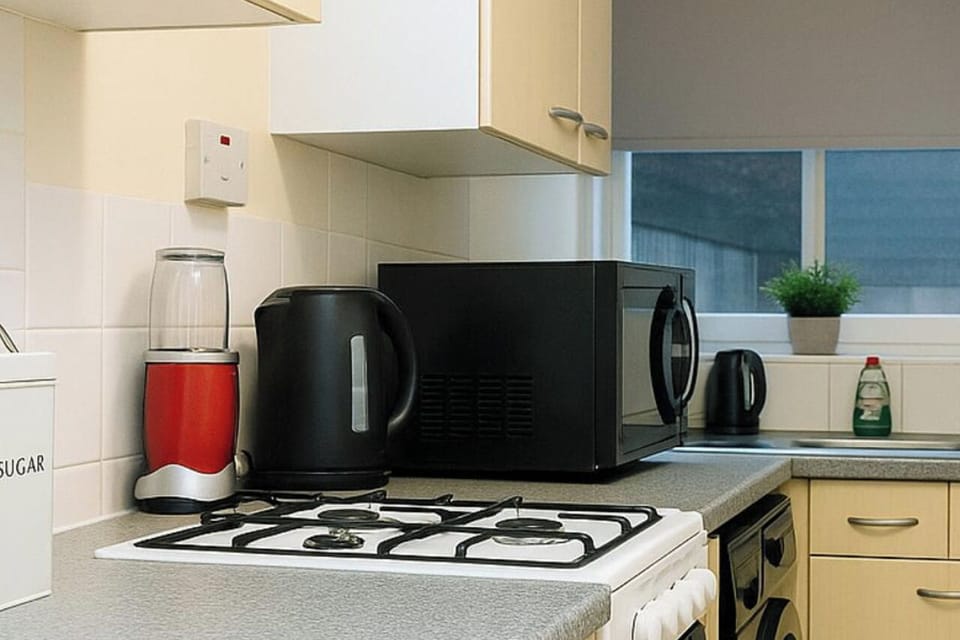 Kitchen with microwave, kettle and other amenities