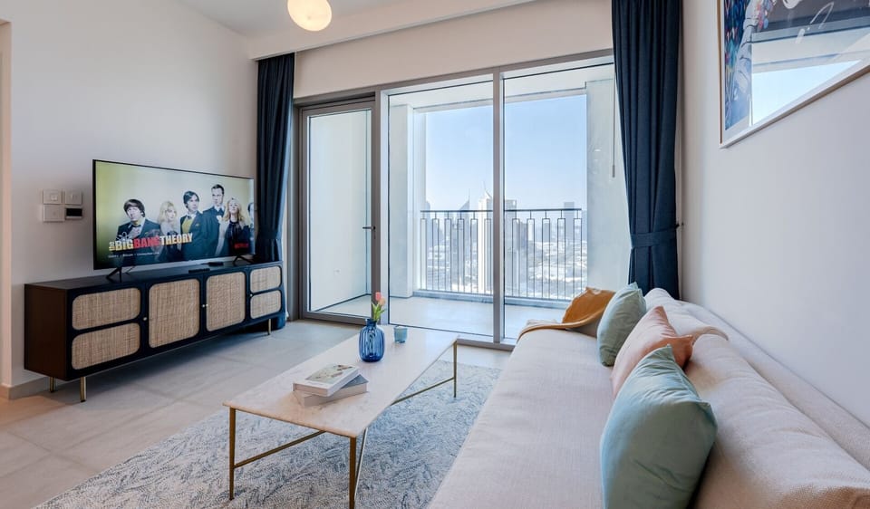 Living room with attached sofa and Ultra Smart TV.
