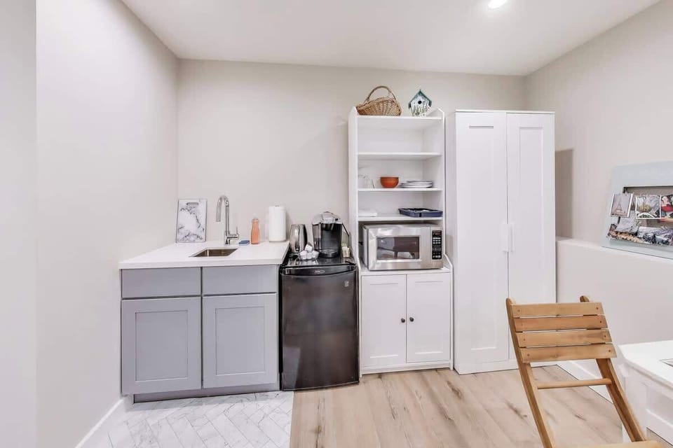 Kitchen area has a small fridge for storing leftovers, a microwave for re-heating them, and a keurig to make coffee or tea.