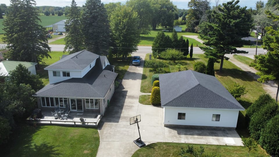 OVERALL:  Aerial view of the larger house on the hill.  (The building on the right is a detached garage that is not available for guest usage.)