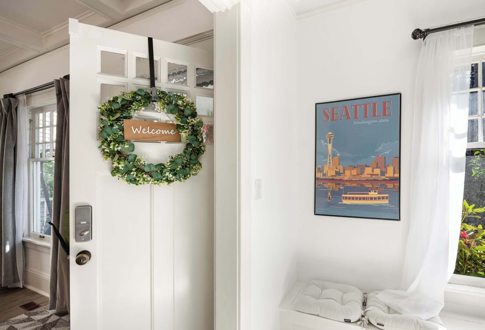 A warm welcome awaits you with a charming entryway adorned with a Seattle-themed art piece.