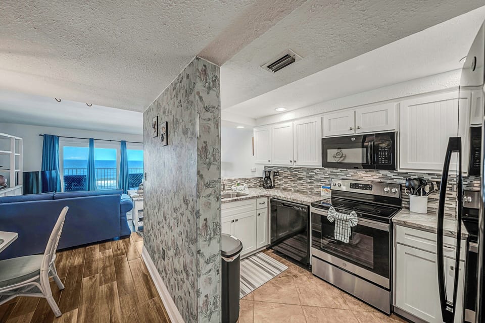 The fully equipped kitchen features granite countertops, updated cabinets & appliances, and has everything you need to prepare meals for family & friends.