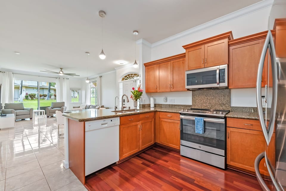 A complete kitchen setup with all the essentials, including a microwave, oven, and everything you need for a convenient stay.