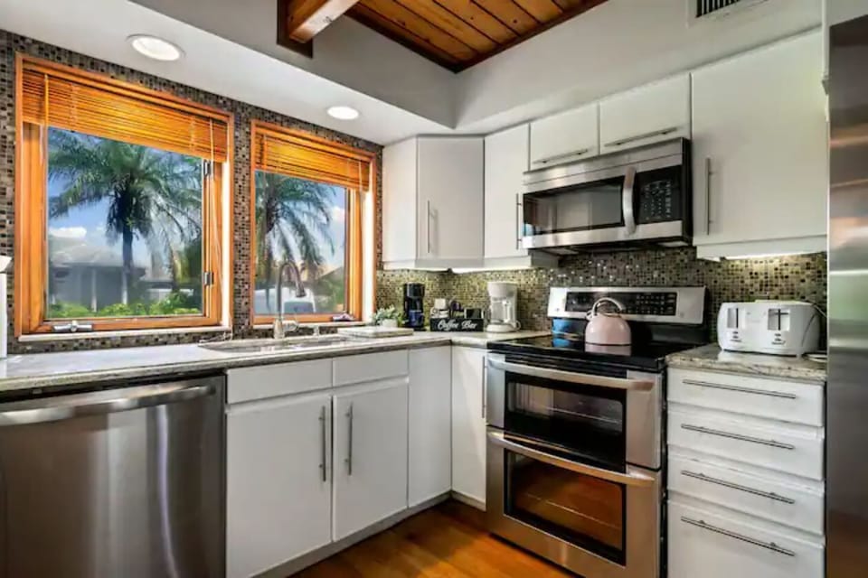 Cozy kitchen with large windows offering a stunning waterfront view