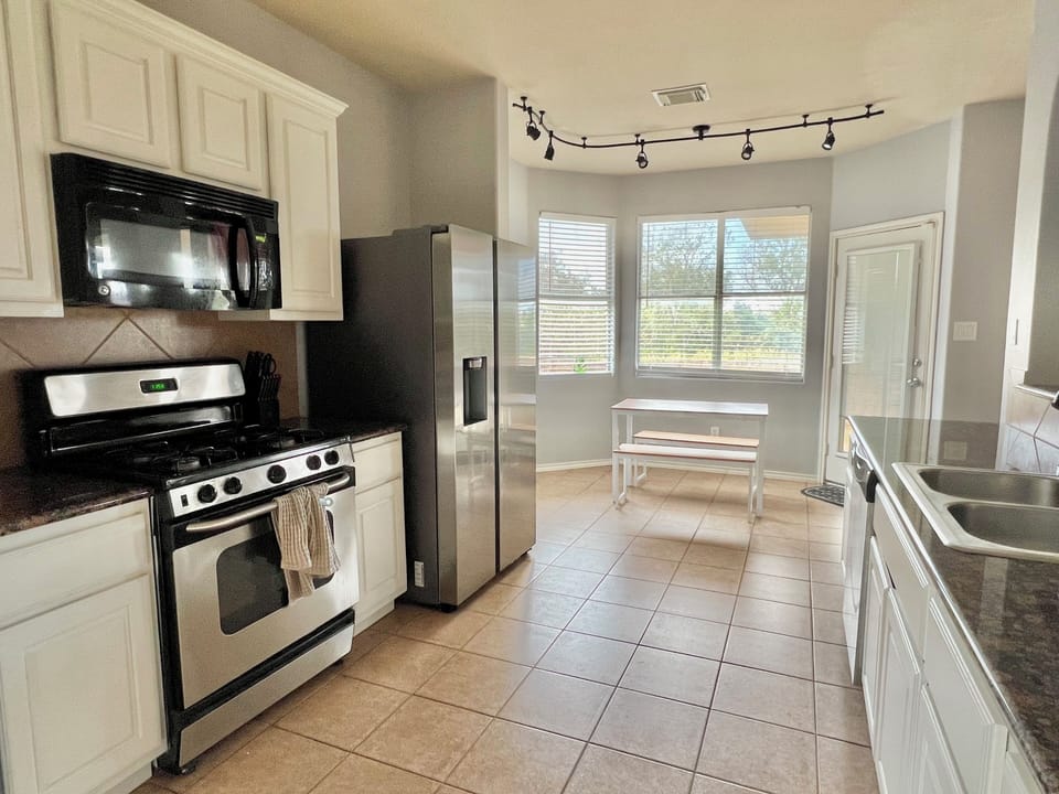 Spacious kitchen with kitchen nook and small table
