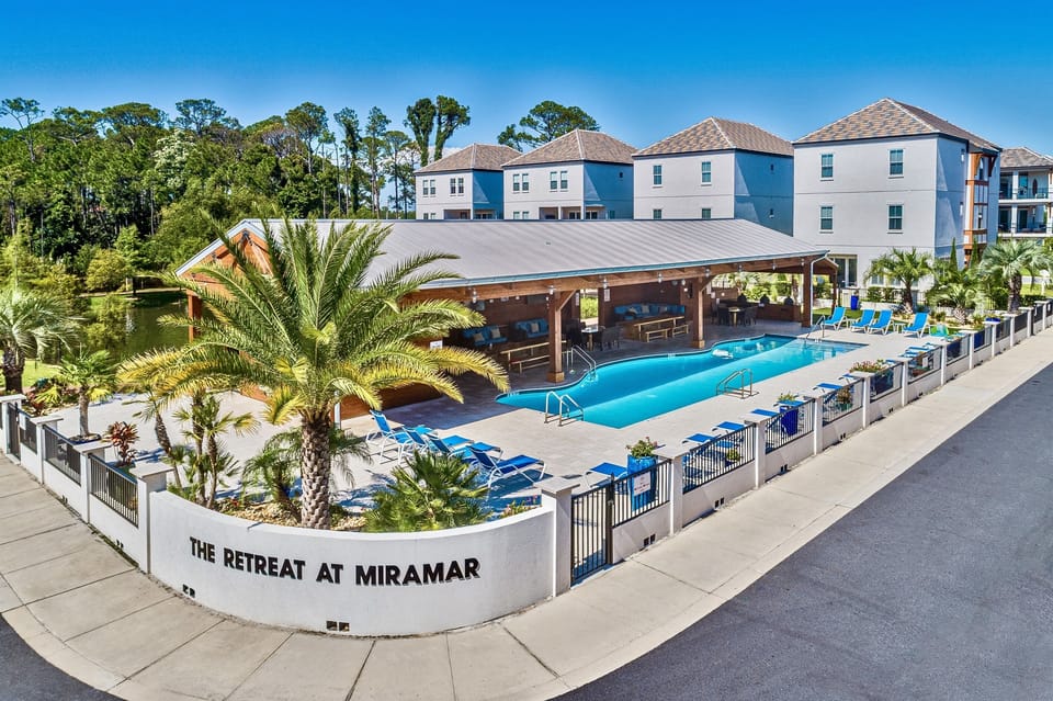 Resort-Style Pool & Clubhouse — Enjoy exclusive access to the 90-ft HEATED community pool, cushioned lounge seating, covered pavilion with 7 Green Egg grills, large dining tables, and big-screen TVs—perfect for relaxing, cookouts, and group gatherings.