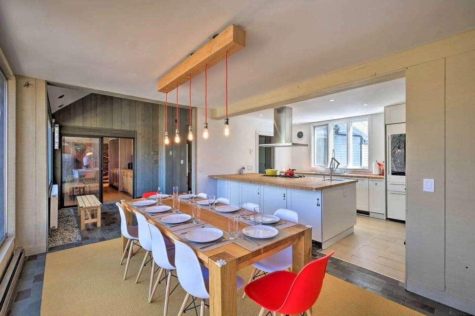 Dining room with large table that can accommodate 10 people and also have a portable, folding table with folding chairs if needed. Beautiful view facing Mt. Equinox.  