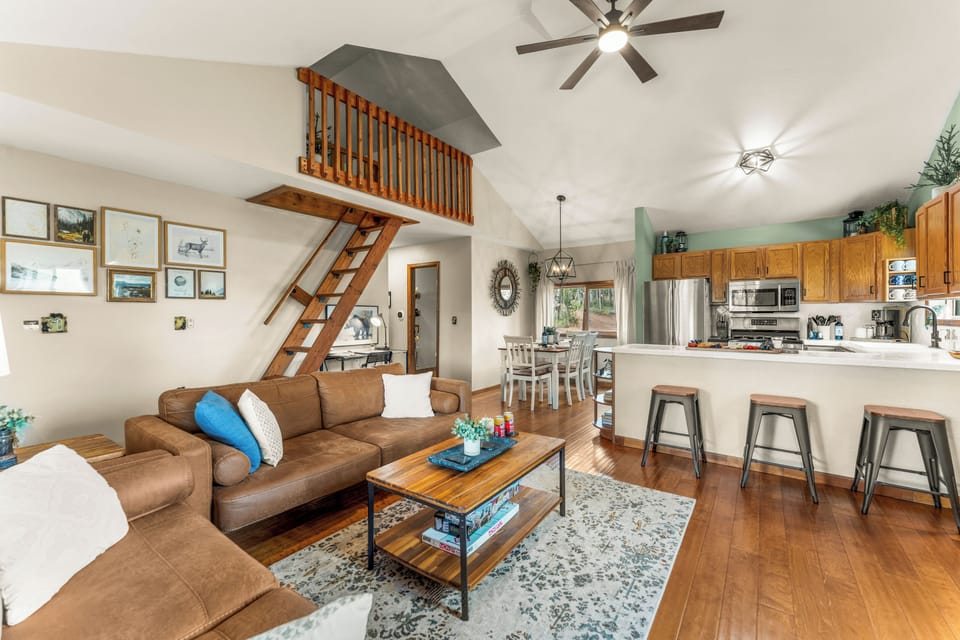 Cozy cabin vibes with leather seating, soft light, and an electric fireplace