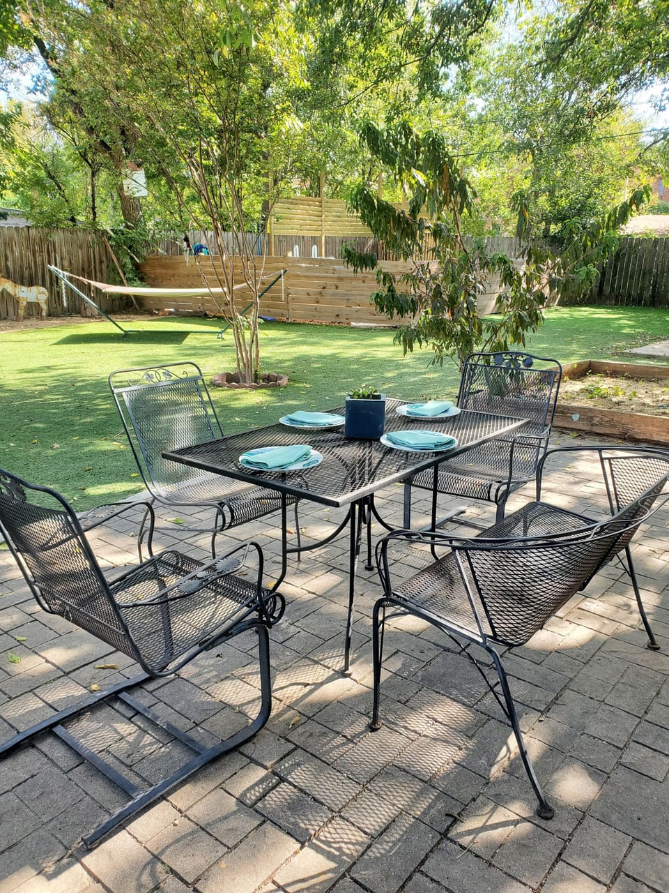 Private backyard patio and artificial turf yard