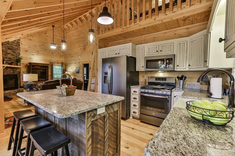 Fully stocked kitchen with a beautiful granite island and some extra seating