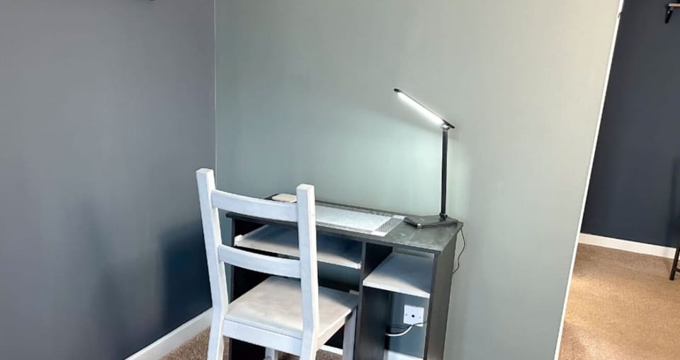 Convenient workspace designed for guests who need to work or study. Equipped with a sturdy desk, organized shelving, and proper lighting, this dedicated area provides a comfortable environment away from the bedroom.