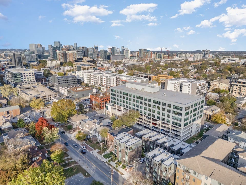 Private partially covered rooftop deck with lounge area, fire pit, and additional outdoor seating with stunning Nashville skyline views. (4th Floor)
