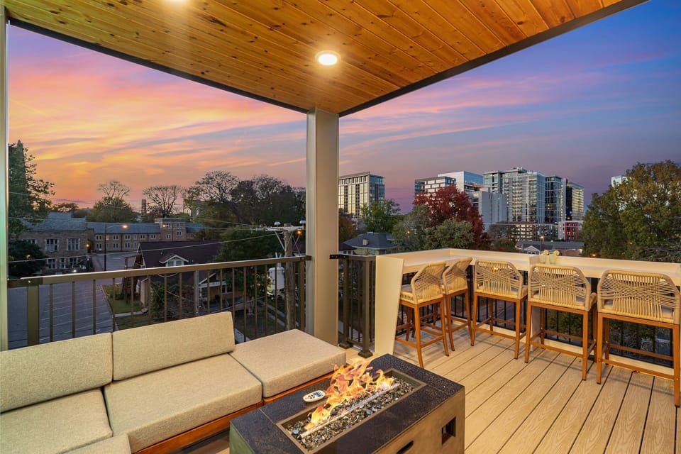 Private partially covered rooftop deck with lounge area, fire pit, and additional outdoor seating with stunning Nashville skyline views. (4th Floor)